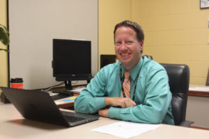 tim sopko man at desk with laptop in office